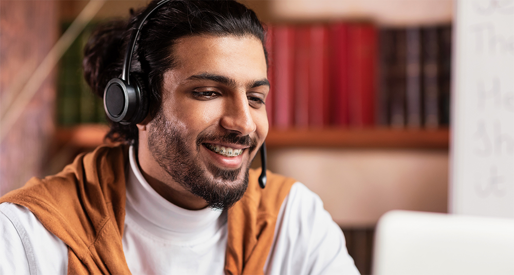 stock photo of man wearing headset at computer