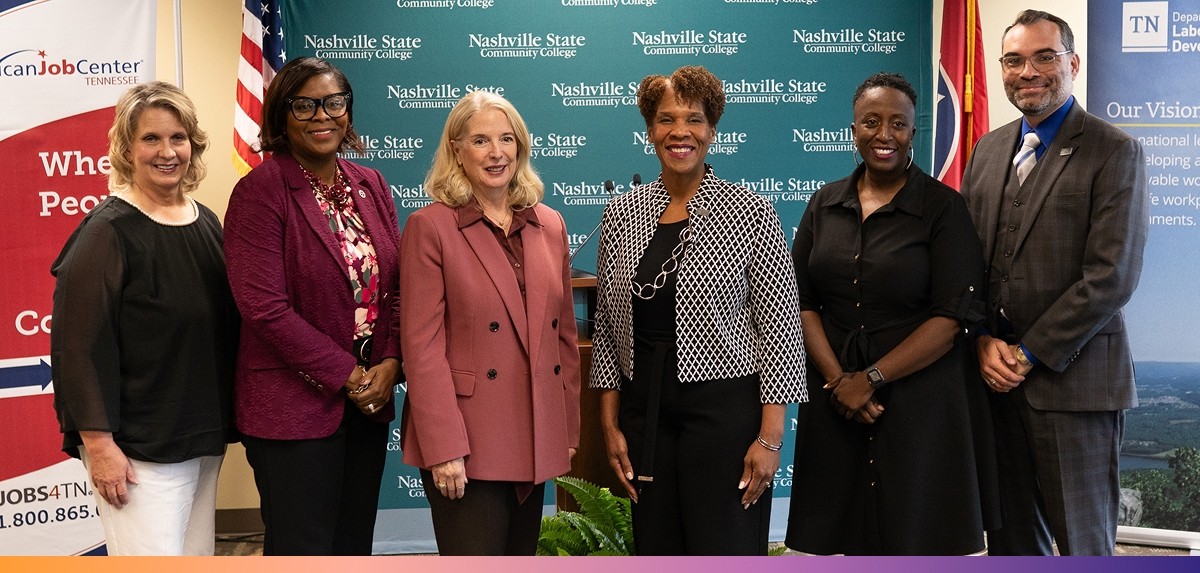 Five women and one man pose for a photo in front of a Nashville State Community College backdrop