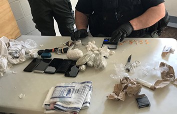 Contraband Search Netted Cellphones, Homemade Knives, Tobacco & Illegal Substances Photo of Cell Phones and Drugs