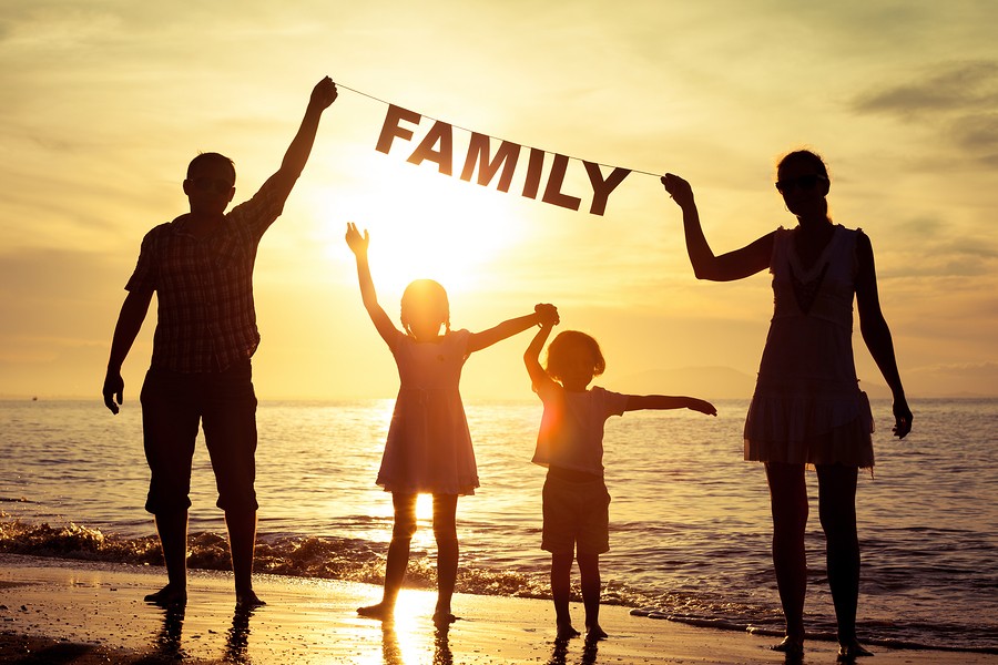 Therapeutic Foster Care Therapeutic Foster Care: silhouette of two parents and two children with banner reading FAMILY on beach at sunset