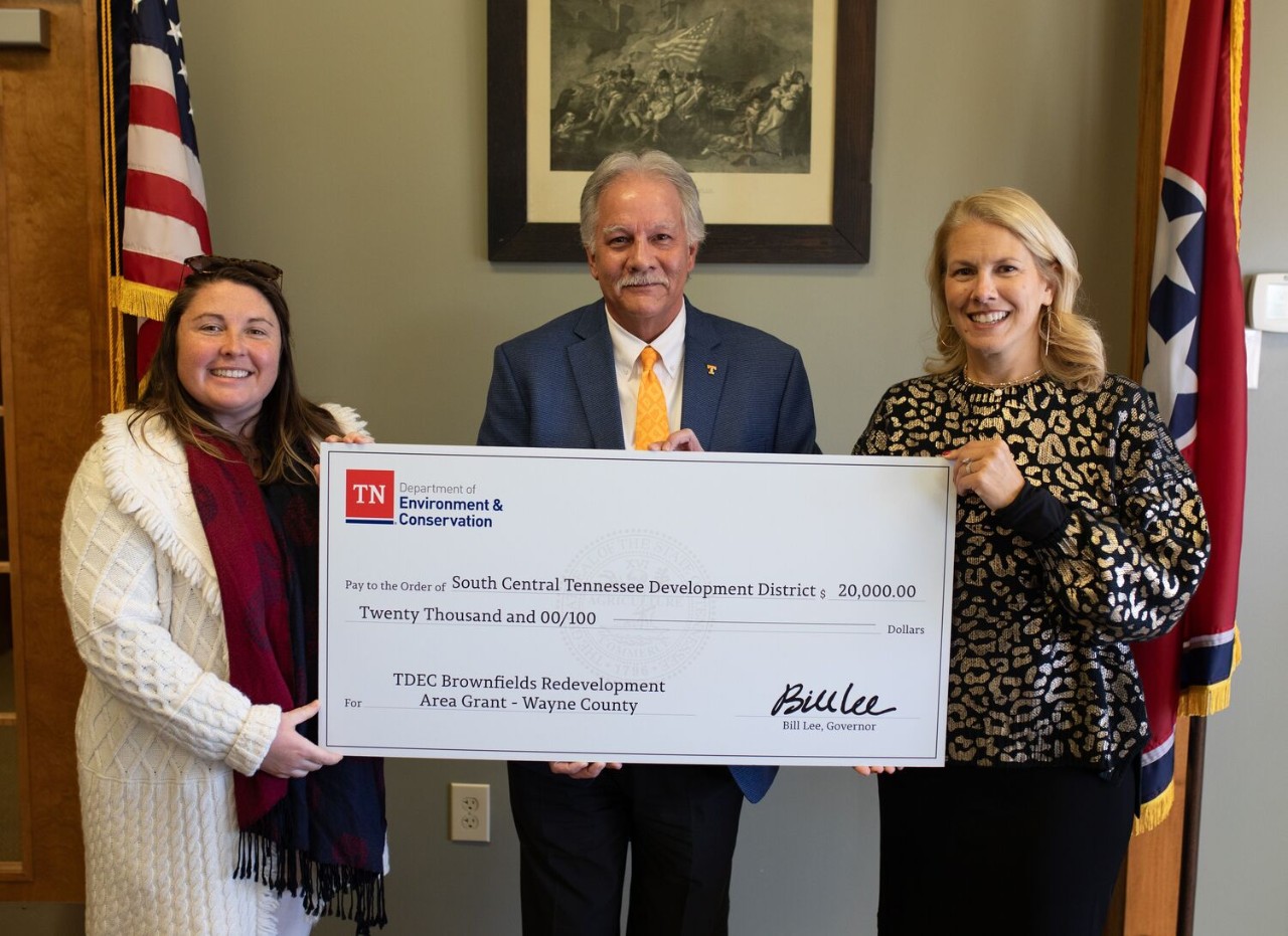 The Tennessee Department of Environment and Conservation (TDEC) presents a check for $20,000 to Wayne County for its plans in brownfield redevelopment. From left are Amy Dyman, coordinator of the Brownfield Redevelopment Area Grant program; Wayne County Executive Jim Mangubat; and Lisa Cross, director of Rural Planning Organization/Infrastructure for the South Central Tennessee Development District. The Tennessee Department of Environment and Conservation (TDEC) presents a check for $20,000 to Wayne County for its plans in brownfield redevelopment. From left are Amy Dyman, coordinator of the Brownfield Redevelopment Area Grant program; Wayne County Executive Jim Mangubat; and Lisa Cross, director of Rural Planning Organization/Infrastructure for the South Central Tennessee Development District.