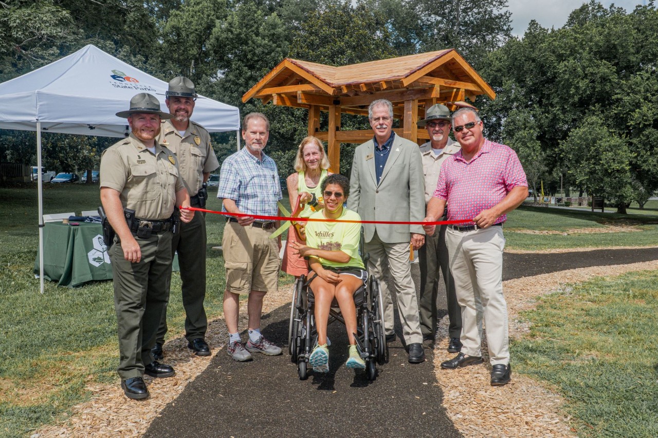 Tennessee State Parks leadership joined lawmakers and members of Achillies International to open a new accessible trail at Henry Horton State Park. L-R: Henry Horton State Park Manager Shaun Rainone, Tennessee State Parks Area Manager Jacob Young, Sen. Joey Hensley, Amy Harris, Sara “Lizzy” Harris, TDEC Deputy Commissioner Greer Tidwell, Tennessee State Parks Director of Operations Kim Moore, and Rep. Todd Warner.