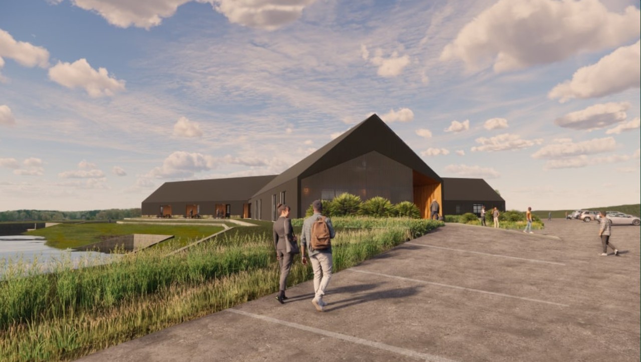 Rendering of the WET Center new building with 2 people walking in the parking lot.