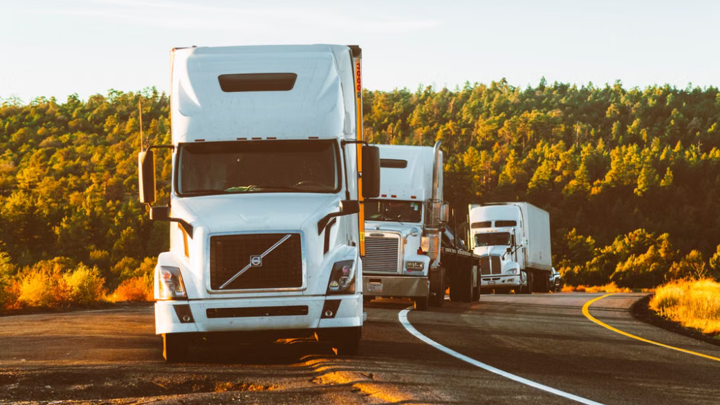 Image of freight trucks parked along a mountain road