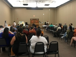 TEEA2 Room of adults sitting in rows of chairs