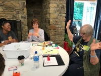 People at a table with a simple motor experiment People at a table with a simple motor experiment
