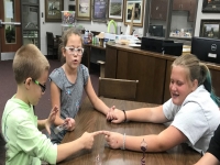 Children doing an energy stick experiment Children doing an energy stick experiment