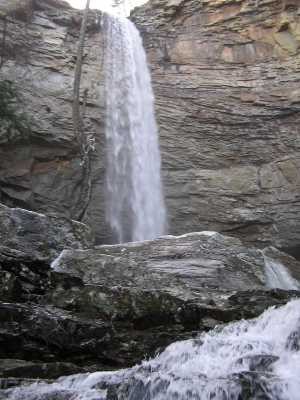 A tall waterfall pours over a cliff