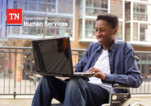 VR_Photo A young man with a physical impairment using a computer outside of a traditional learning environment