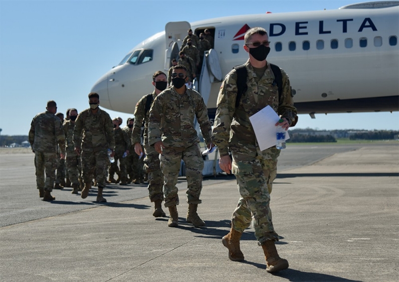 More than 100 Soldiers from the 252nd Military Police Company arrive in Smyrna on March 26, following an 11-month deployment in support of Operation Enduring Freedom. (Photo by Staff Sgt. Tim Cordeiro) Soldiers coming of a plane on a tarmac