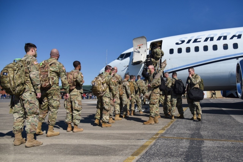 Soldiers with the Tennessee National Guard’s 1st Battalion, 181st Field Artillery Regiment, load an aircraft at Smyrna’s Volunteer Training Site following the unit’s departure ceremony for a 10-month deployment to the Middle East on March 7. (photo by Staff Sgt. Timothy Cordeiro) Soldiers boarding a plane on a runway
