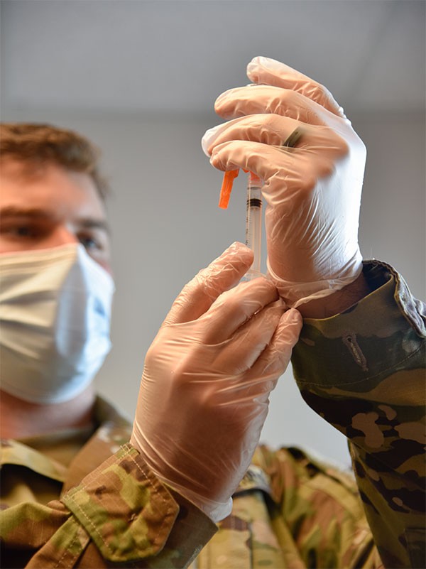 Spc. Anthony Spencer with the Tennessee National Guard prepares a vaccination dose for a patient at the Trousdale County Health Department on June 9. (Photo by Lt. Col. Darrin Haas) Spc. Anthony Spencer with the Tennessee National Guard prepares a vaccination dose for a patient at the Trousdale County Health Department on June 9. (Photo by Lt. Col. Darrin Haas)