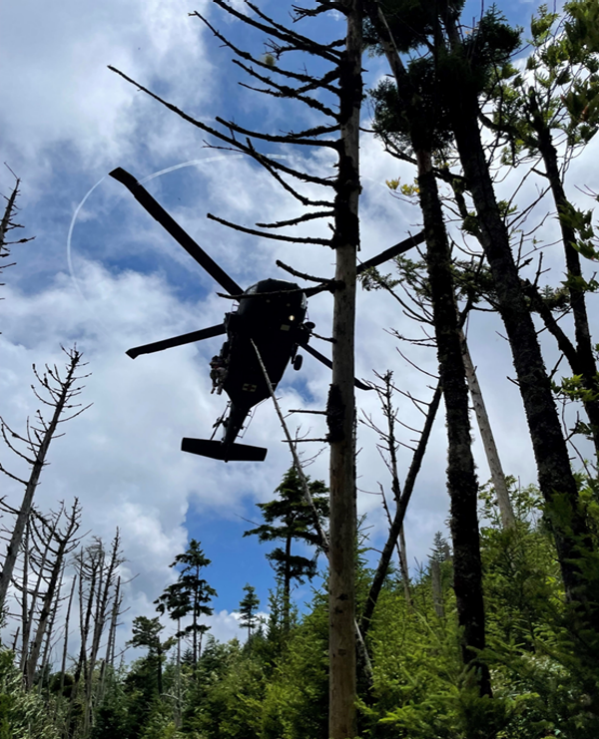 A Tennessee Army National Guard UH-60 Blackhawk helicopter aircrew prepares to hoist a hiker with a life-threatening illness, and a Tennessee National guard Flight Paramedic, into the helicopter on Mount LeConte at the Great Smoky Mountain National Park area, July 19. (Photo from the Tennessee National Guard)