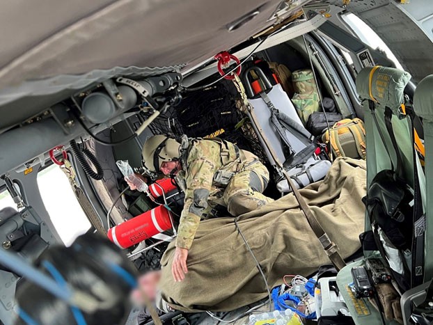An aircrewman from the Tennessee Army National Guard comforts a patient rescued from the flooding in eastern Kentucky while being flown to a local hospital, July 28. (submitted photo) An aircrewman from the Tennessee Army National Guard comforts a patient rescued from the flooding in eastern Kentucky while being flown to a local hospital, July 28. (submitted photo)