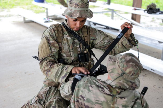 Senior Airman Laurence Rodgers simulates first-aid during the two-week patrol course, Aug. 6-20 held in Lavinia. (Photos by Capt. Kealy Moriarty)