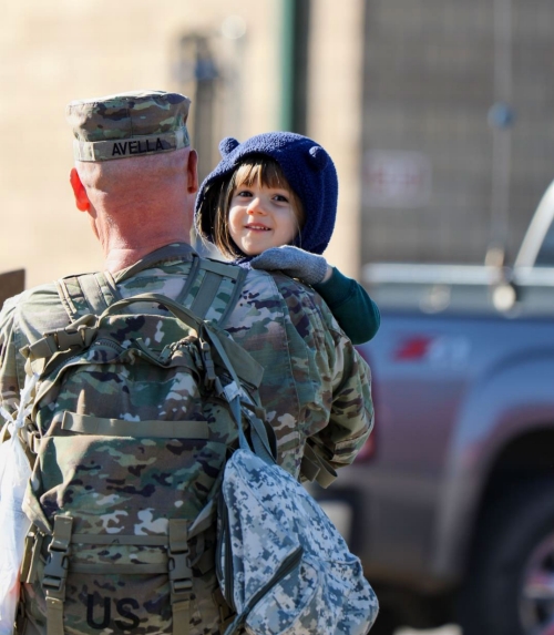 Master Sgt. Michael Avella holds his son, Michael, for the first time in 10-months at Smyrna’s Volunteer Training Site, Dec. 14, after returning from a successful deployment overseas with the Memphis based 730th Composite Supply Company. (photo by Cpl. Kalina Hyche)