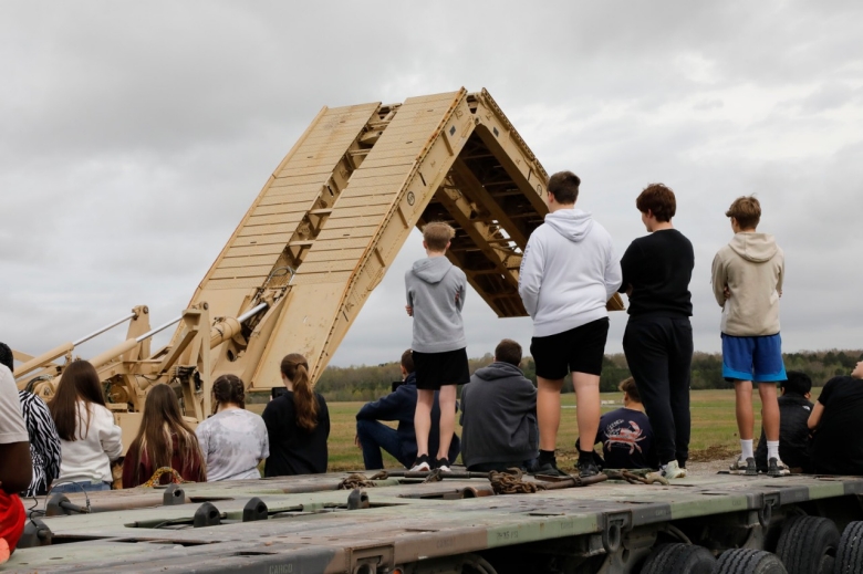 Students from Coffee County Central and Tullahoma High Schools watch a demonstration of the M-60 Armored Vehicle Launched Bridge being deployed during a career day at the Tullahoma National Guard Armory on April 6. (photo by Lt. Col. Marty Malone) Students from Coffee County Central and Tullahoma High Schools watch a demonstration of the M-60 Armored Vehicle Launched Bridge being deployed during a career day at the Tullahoma National Guard Armory on April 6. (photo by Lt. Col. Marty Malone)