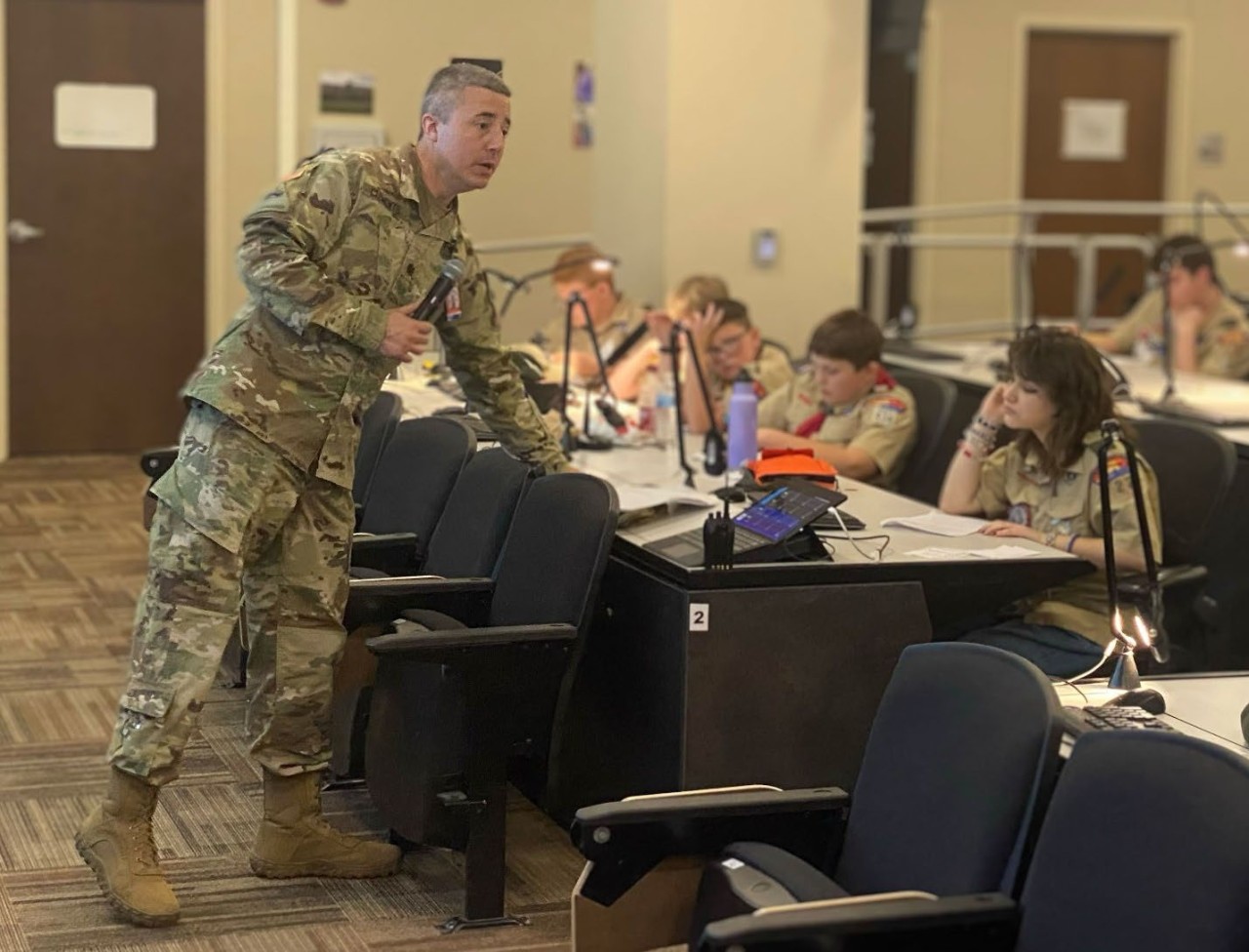 Lt. Col. Dallas Clements teaches the radio merit badge in the Joint Operations Center during the 3rd Annual Merit Badge University hosted by the Tennessee Military Department at Nashville’s Joint Force Headquarters, April 27. (photo by Staff Sgt. Matthew Brown) Lt. Col. Dallas Clements teaches the radio merit badge in the Joint Operations Center during the 3rd Annual Merit Badge University hosted by the Tennessee Military Department at Nashville’s Joint Force Headquarters, April 27. (photo by Staff Sgt. Matthew Brown)