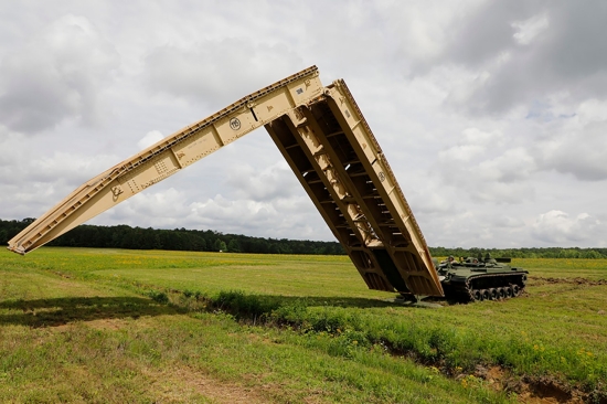 Tennessee Army National Guard Soldiers assigned to the 190th Engineer Company employ the M60 Armored Vehicle Launch Bridge over a simulated flooding stream at the Volunteer Training Site in Tullahoma, Saturday, May 18. As the bridge was deployed, the Soldiers worked together to ensure its stability and security, demonstrating their expertise in setting up critical infrastructure in challenging terrain. (U.S. Army National Guard photo by Sgt. First Class Mathieu Perry) Tennessee Army National Guard Soldiers assigned to the 190th Engineer Company employ the M60 Armored Vehicle Launch Bridge over a simulated flooding stream at the Volunteer Training Site in Tullahoma, Saturday, May 18. As the bridge was deployed, the Soldiers worked together to ensure its stability and security, demonstrating their expertise in setting up critical infrastructure in challenging terrain. (U.S. Army National Guard photo by Sgt. First Class Mathieu Perry)