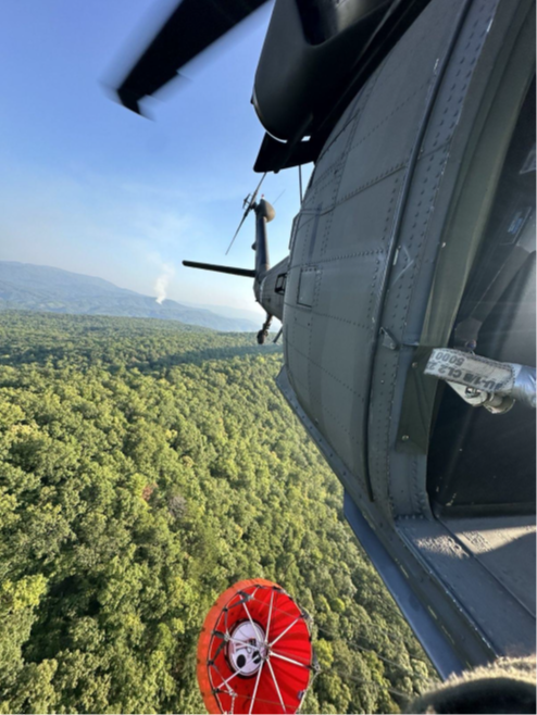 A Tennessee National Guard UH-60 Blackhawk helicopter, from Knoxville’s 1-230th Assault Helicopter Battalion, flies to a nearby river to pick up water with a Bambi Bucket suspended under the aircraft. The hundreds of gallons of water were used to fight wildfires in the Great Smoky Mountains National Park, August 27. (submitted Tennessee National Guard photo) A Tennessee National Guard UH-60 Blackhawk helicopter, from Knoxville’s 1-230th Assault Helicopter Battalion, flies to a nearby river to pick up water with a Bambi Bucket suspended under the aircraft. The hundreds of gallons of water were used to fight wildfires in the Great Smoky Mountains National Park, August 27. (submitted Tennessee National Guard photo)