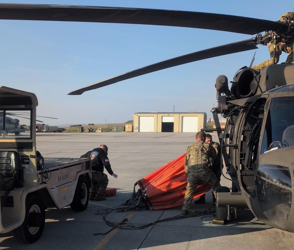 Photo of Soldiers from Knoxville’s 1-230th Assault Helicopter Battalion loading a Bambi Bucket into a UH-60 Blackhawk helicopter to support wildfire response in Anderson County Photo of Soldiers from Knoxville’s 1-230th Assault Helicopter Battalion loading a Bambi Bucket into a UH-60 Blackhawk helicopter to support wildfire response in Anderson County