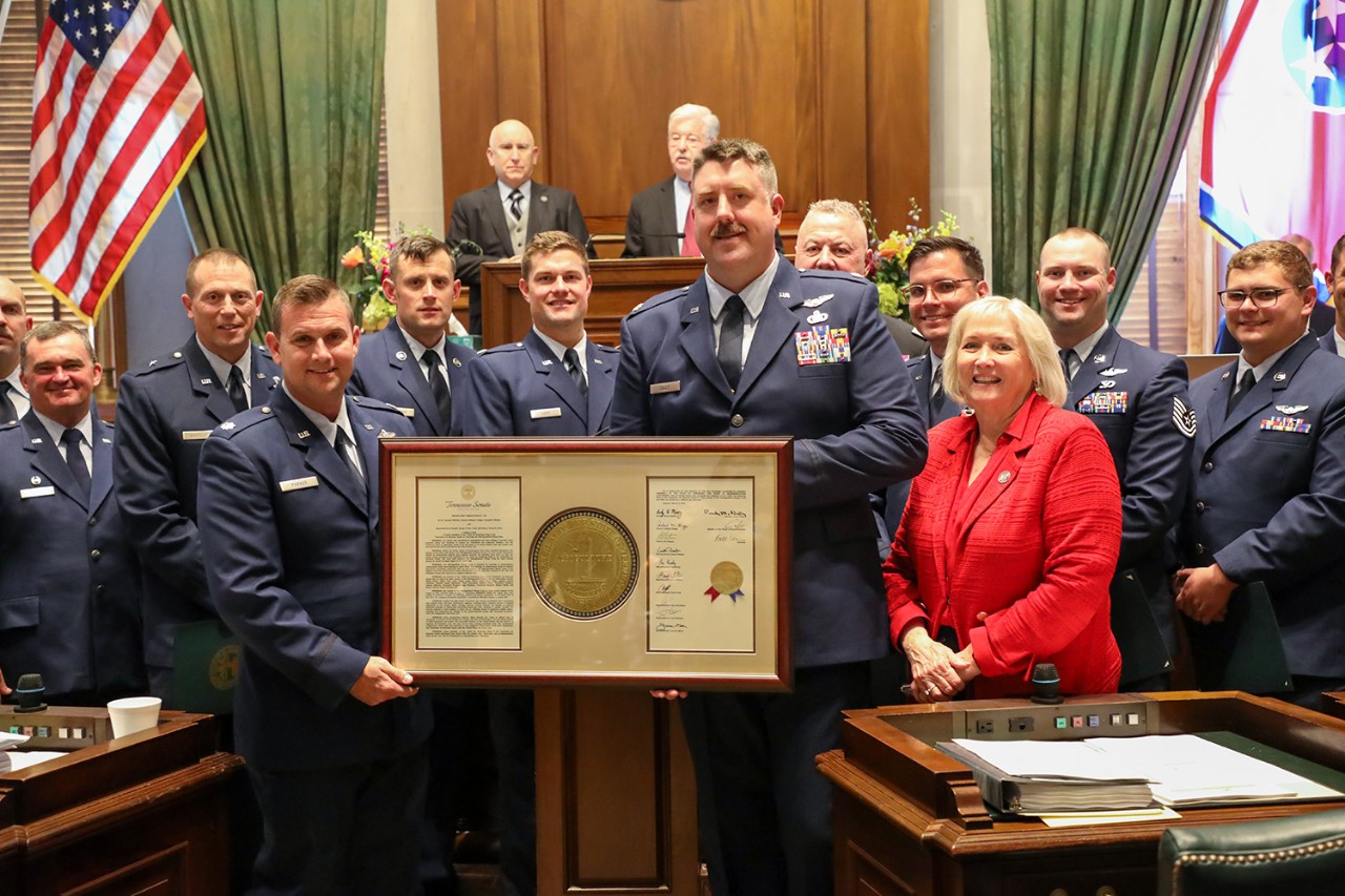 Members of the Tennessee Air National Guard’s 134th Air Refueling Wing hold Senate Joint Resolution 150, which was presented to them by Senator Becky Massey, a member of the Tennessee Senate from 6th District, in Tennessee’s Senate chambers, April 14. The Resolution was in honor of the Airmen’s heroism resulting in the awarding of Distinguished Flying Crosses while deployed for Operation True Promise. (photo by Lt. Col. Darrin Haas) Members of the Tennessee Air National Guard’s 134th Air Refueling Wing hold Senate Joint Resolution 150, which was presented to them by Senator Becky Massey, a member of the Tennessee Senate from 6th District, in Tennessee’s Senate chambers, April 14. The Resolution was in honor of the Airmen’s heroism resulting in the awarding of Distinguished Flying Crosses while deployed for Operation True Promise. (photo by Lt. Col. Darrin Haas)