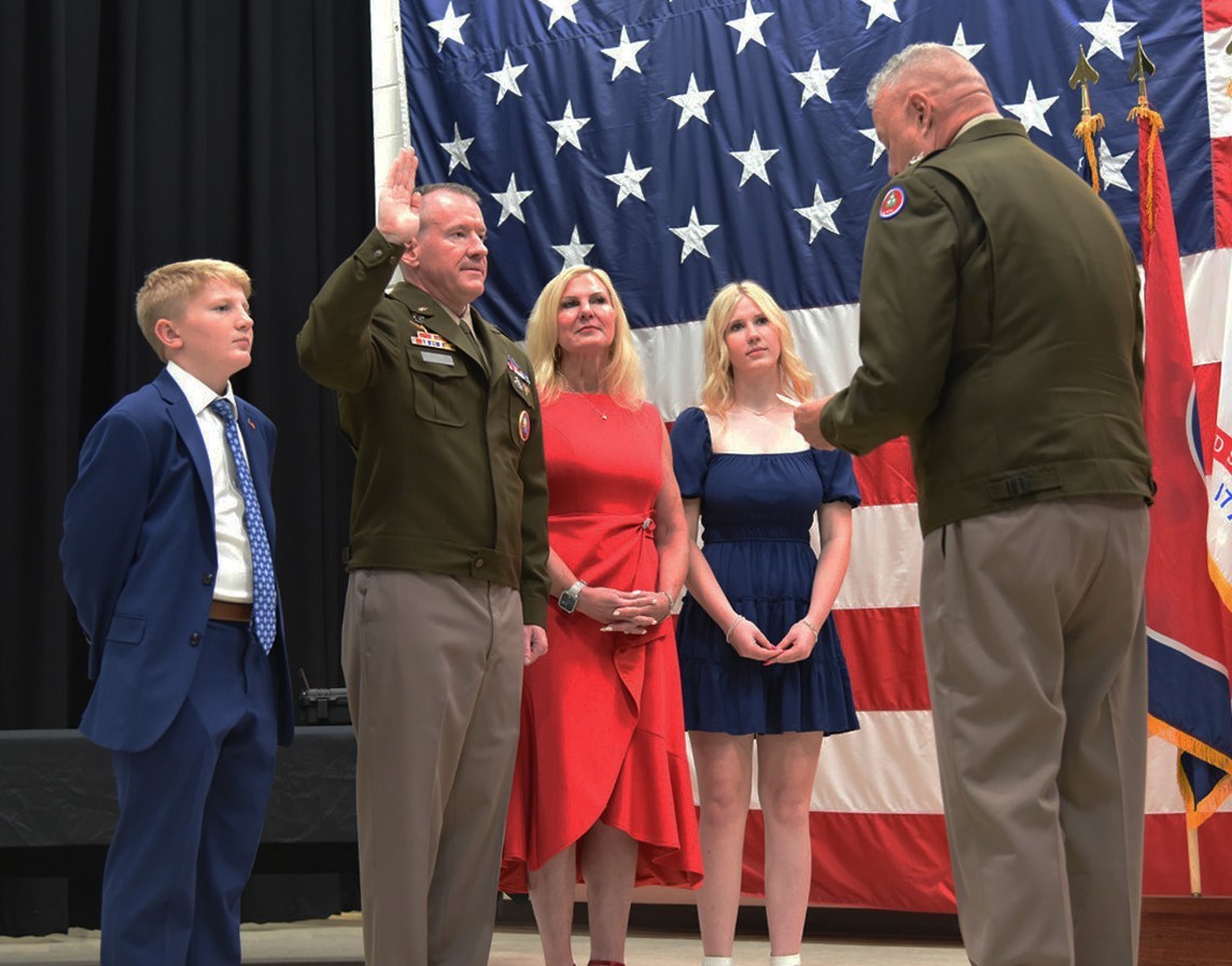 Tennessee’s Adjutant General, Maj. Gen. Warner Ross, administers the oath of office to newly promoted Brig. Gen. Mark Tyndall, during Tyndall’s promotion ceremony held at the Tennessee National Guard’s Joint Force Headquarters in Nashville on August 1. Tyndall’s wife Kim, and their two children, Katie and Jake, participate in the ceremony. (photo by retired Sgt. 1st Class Edgar Castro) 