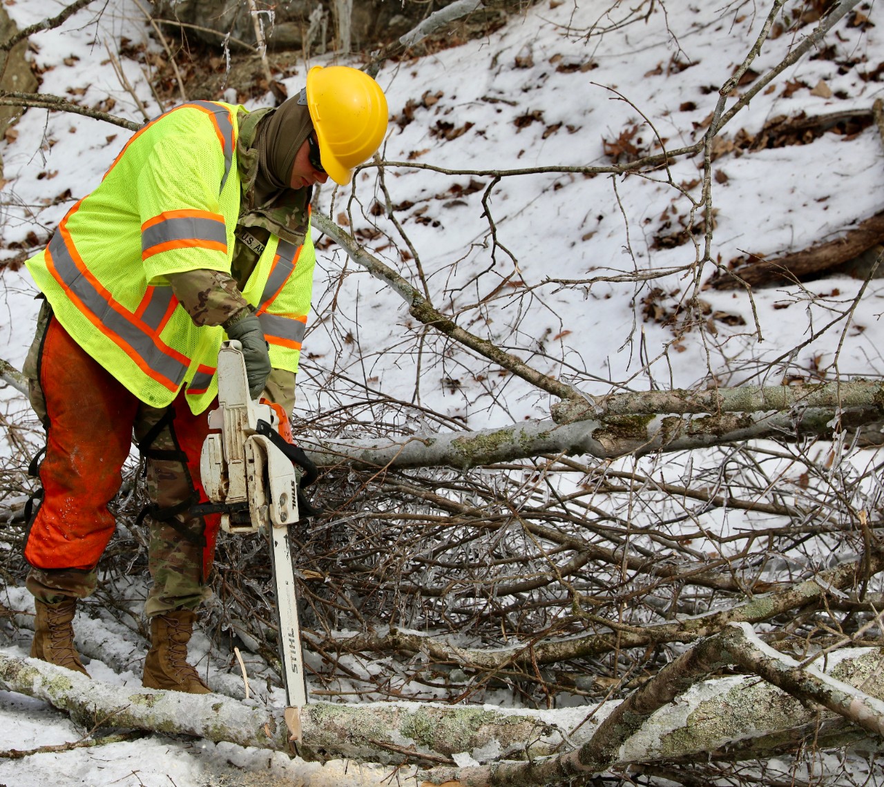 A Soldier with the Tennessee Army National Guard’s 212th Engineer Company uses a chain saw as part of a “Cut and Toss” team, clearing trees and debris so NES can access powerlines and restore power to our local communities in Davidson County on January 31. Guardsmen are supporting state, county, and local emergency responders as they assist Tennesseans affected by Winter Storm Fern. (photo by Capt. Kealy Moriarty) A Soldier with the Tennessee Army National Guard’s 212th Engineer Company uses a chain saw as part of a “Cut and Toss” team, clearing trees and debris so NES can access powerlines and restore power to our local communities in Davidson County on January 31. Guardsmen are supporting state, county, and local emergency responders as they assist Tennesseans affected by Winter Storm Fern. (photo by Capt. Kealy Moriarty)