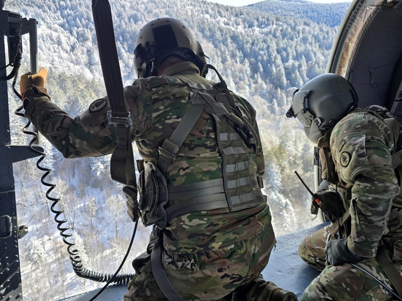 Sgt. Christopher Burke, a Blackhawk crew chief, and Master Sgt. Tracy Banta, a flight paramedic with the Tennessee Army National Guard, begin hoisting an injured hiker with severe cold weather injuries into a hovering UH-60 Blackhawk helicopter in the Great Smoky Mountains National Park, February 24. (submitted photo)    