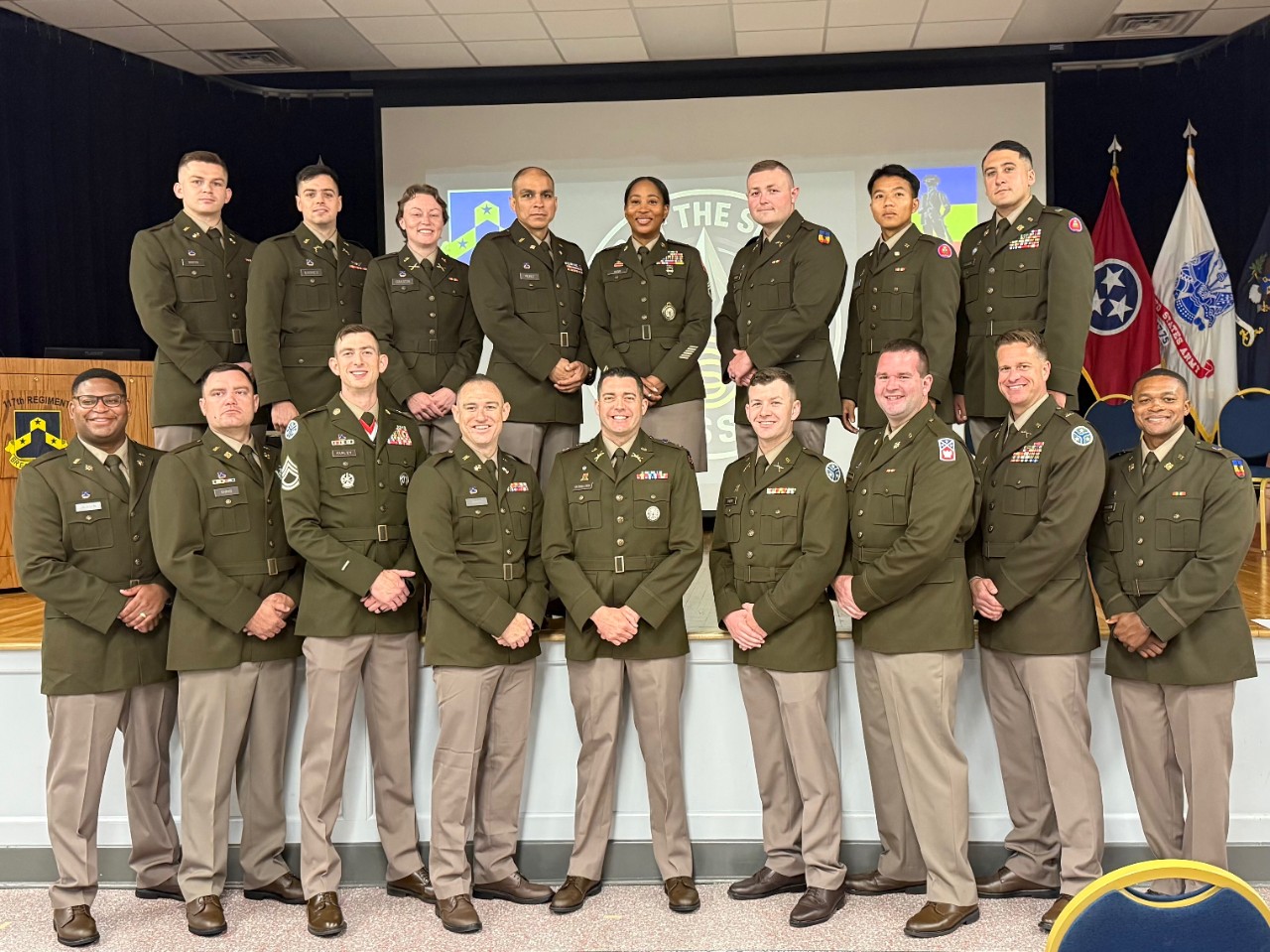 Sixteen National Guardsmen graduated from the Tennessee Army National Guard’s 10-month-long Officer Candidate School, led by the 117th Regional Training Institute, during a special ceremony held at Smyrna’s Volunteer Training Center, April 19. The OCS class pose with one of their instructors prior to the ceremony. (photo by Capt. Bradley Warren) Photo of a group of National Guardsmen in dress uniforms