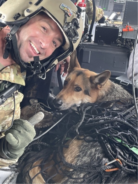 Sgt. 1st Class John Sharbel, a flight paramedic with the Tennessee Army National Guard’s 1-230th Assault Helicopter Battalion, takes a photograph with Jack, a German Shepherd, just after being hoisted into a Blackhawk helicopter during a rescue after being trapped in a ravine with his owner overnight in the Cherokee National Forest, May 2. (submitted photo) Sgt. 1st Class John Sharbel, a flight paramedic with the Tennessee Army National Guard’s 1-230th Assault Helicopter Battalion, takes a photograph with Jack, a German Shepherd, just after being hoisted into a Blackhawk helicopter during a rescue after being trapped in a ravine with his owner overnight in the Cherokee National Forest, May 2. (submitted photo)