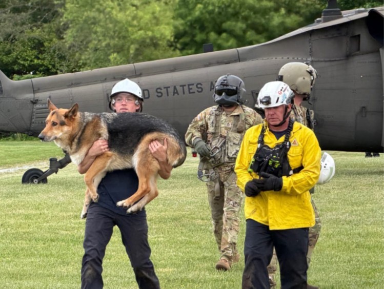 Rescue Team members unload Jack, a German Shepherd, from a Tennessee Army National Guard Blackhawk helicopter during a rescue where he and his owner were trapped in a ravine overnight in the Cherokee National Forest, May 2. (submitted photo) Rescue Team members unload Jack, a German Shepherd, from a Tennessee Army National Guard Blackhawk helicopter during a rescue where he and his owner were trapped in a ravine overnight in the Cherokee National Forest, May 2. (submitted photo)