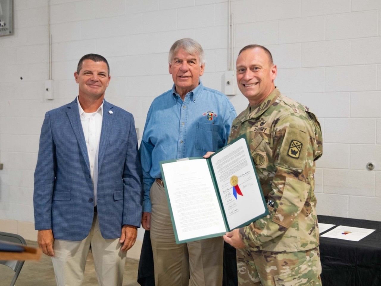 Tennessee State Rep. Chris Hurt, left, Tennessee State Sen. Ed Jackson, center, and Lt. Col. Scotty Sewell, current commander of the 168th Military Police Battalion, pose with a joint resolution honoring the battalion during a ceremony in Dyersburg, September 12. The Tennessee General Assembly recognized the battalion for its 13-month deployment supporting Joint Task Force–Southern Border. (U.S. Army National Guard photo by 1st Lt. Justin Woolen) 