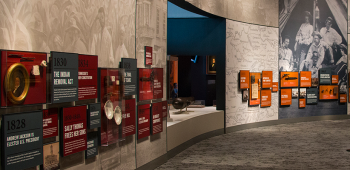 Museum patrons examine the Women's Suffrage exhibit. 