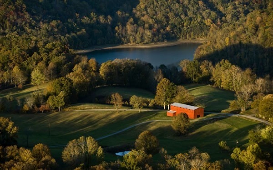 Clay County Community Comprehensive Plan A red barn sits among rolling fields and trees near a small pond in a rural landscape.