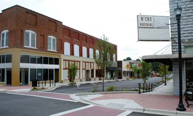 Dickson Downtown Revitalization A small-town downtown street features brick sidewalks and historic storefronts.