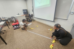 Picture showing students analyzing a model crime scene 