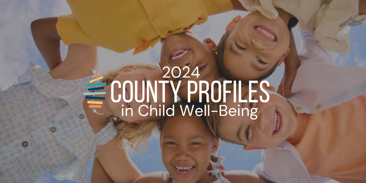 Copy of 2023 County Profiles (Banner (Landscape)) - 2 Smiling kids looking circled in a huddle, looking down while smiling at camera.