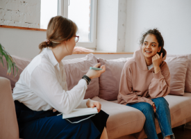 teenage girl sitting with counselor