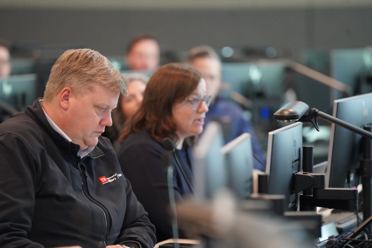 Associate Director Chris Johnson in the State Emergency Operations Center. Man on computer.
