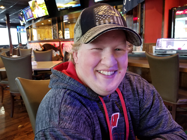 Timothy smiling in a restaurant