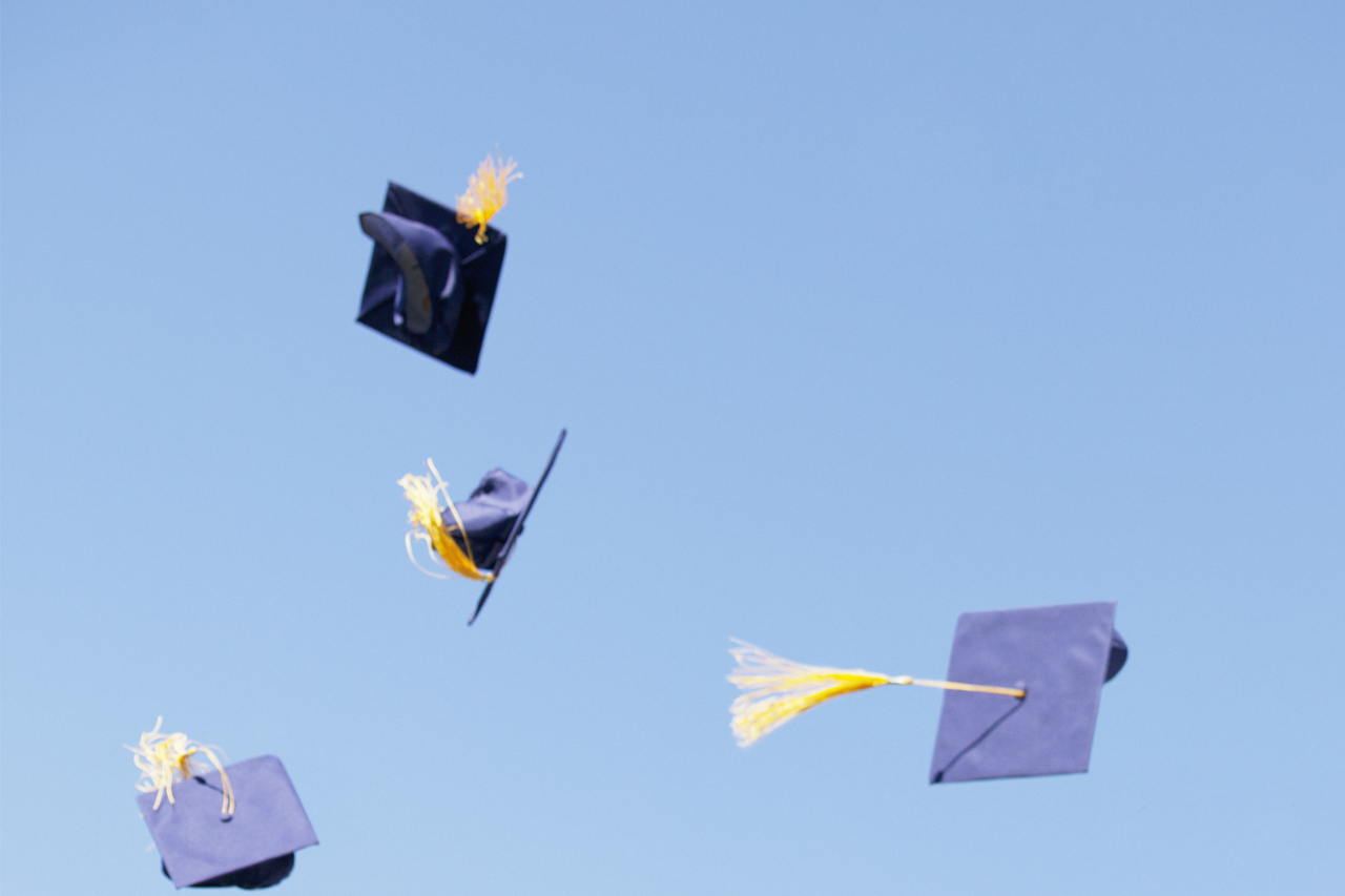 access_academics_studentsuccess_committee graduation caps in the air