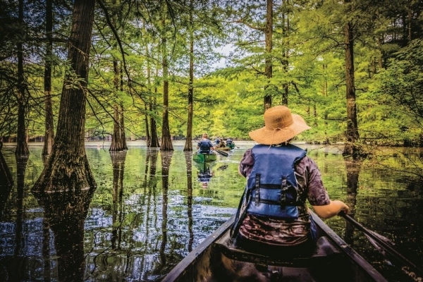 Slow travels Man rowing in canoe