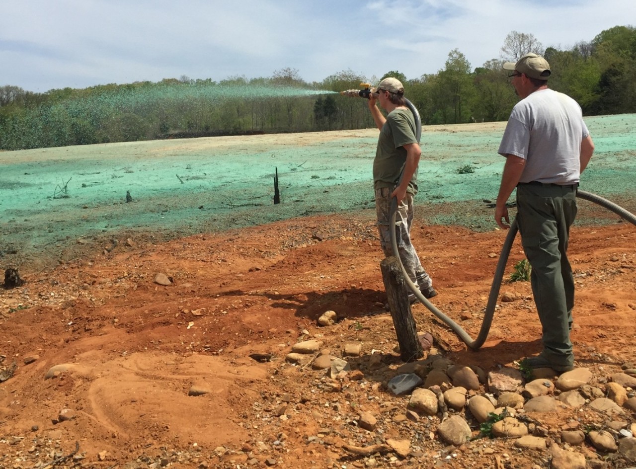 Summer intern hydroseeding on Boone Reservoir during drawdown period
