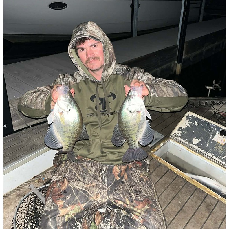 A person showing three fish they caught.