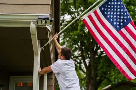 Veteran Placing US Flag on Home Veteran Placing US Flag on Home