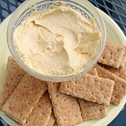 Pumpkin Fluff Dip a bowl of fluffy dip on a plate with graham crackers
