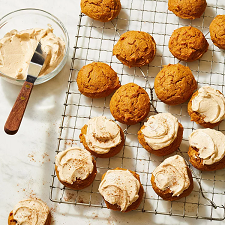a tray of pumpkin spice latte cookies, half of them have icing on them