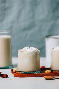 Easy Dairy-free Eggnog a clear glass container of eggnog