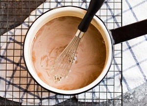 Healthy Hot Chocolate overhead view of hot chocolate in a pan with a whisk